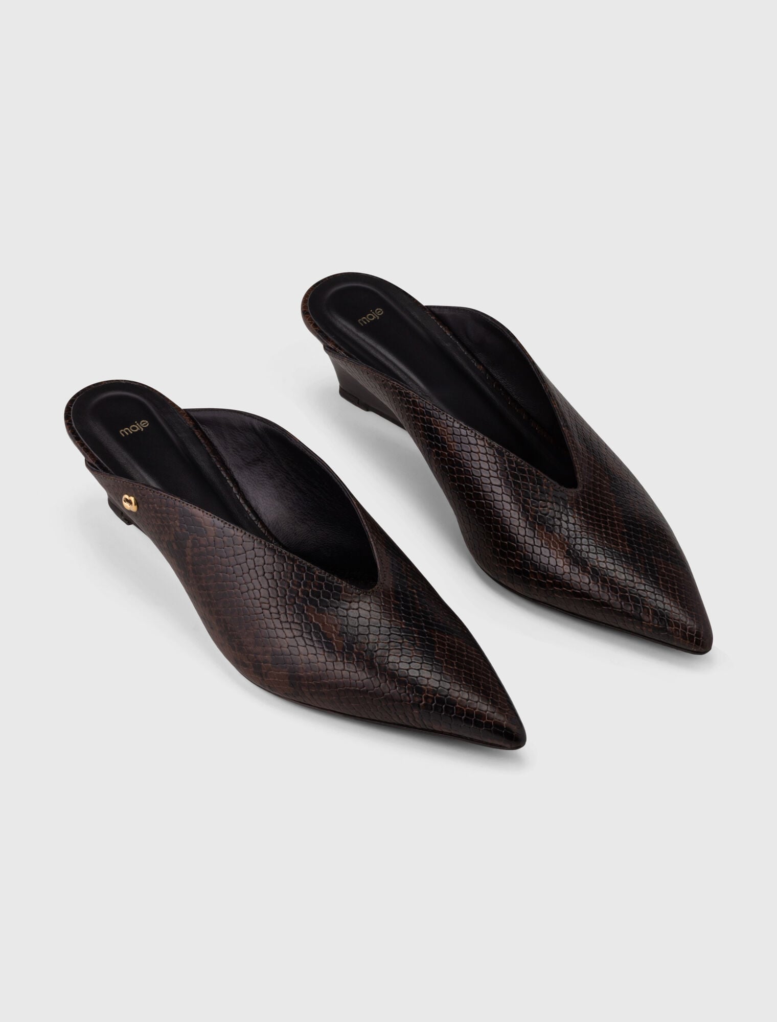 Mules con zeppa in pelle goffrata