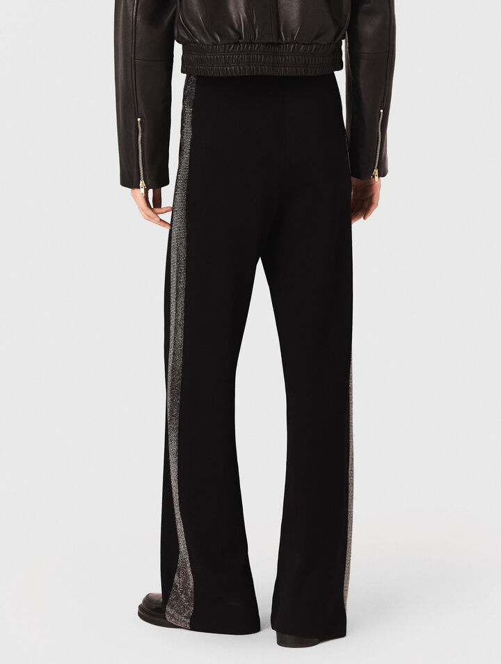 Pantaloni con banda strassata